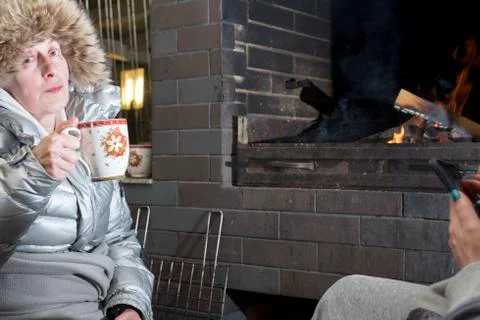 Drinking hot drinks in front of the fireplace 写真素材