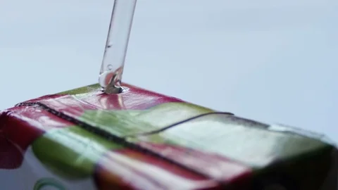 Drinking Juice from a Paper Package through a Straw Stock Footage