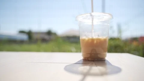 Drinking plastic cup with disposable straw Stock Footage 121510405