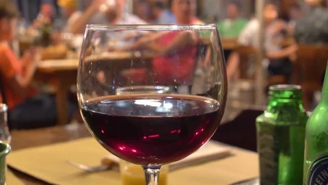 Drinking Red Wine in the Restaurant in the Evening with Background People Bokeh Stock Footage 206071347