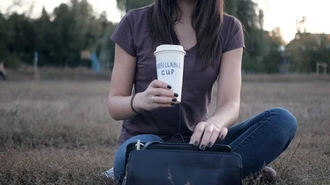 Drinking from refillable cup Stock Footage 117688311