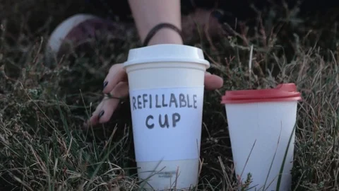 Drinking from refillable cup Stock Footage 117688324