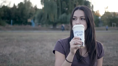 Drinking from refillable cup Stock Footage 117688355