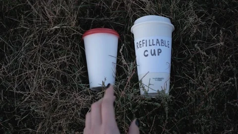Drinking from refillable cup Stock Footage 117688356