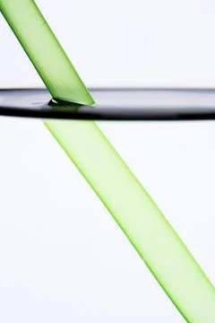 Drinking straw refracted by water Stock Photos