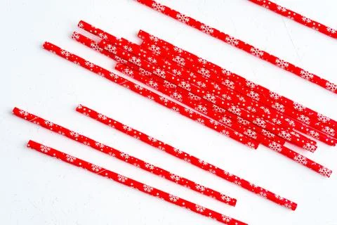 Drinking straws for party on white background. Top view of colorful paper str Photos