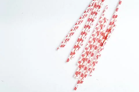 Drinking straws for party on white background. Top view of colorful paper str Stock Photos