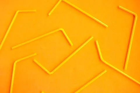 Drinking straws pattern on orange background, top view Stock Photos