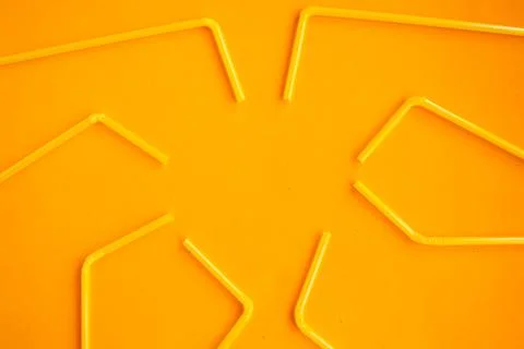 Drinking straws pattern on orange background, top view, copy space Stock Photos