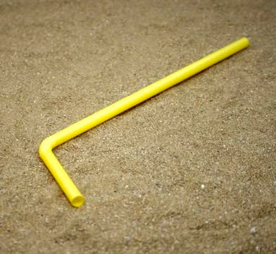 Drinking straws on sand Foto stock