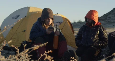 Drinking tea and talking while camping Stock Footage 90405978
