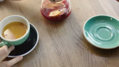 Drinking tea in cafe two cups of hot fruit tea beverages healthy drink red Stock Footage 208845310