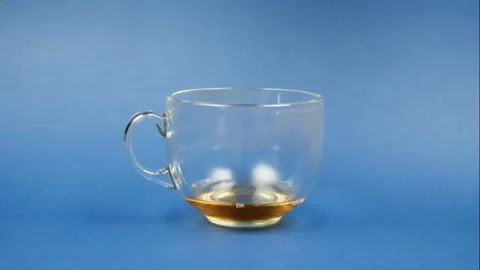 Drinking tea from a glass on blue background. Stop Motion animation Video stock 130520726