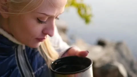 Drinking from a thermos on the rocks Video stock 68867496