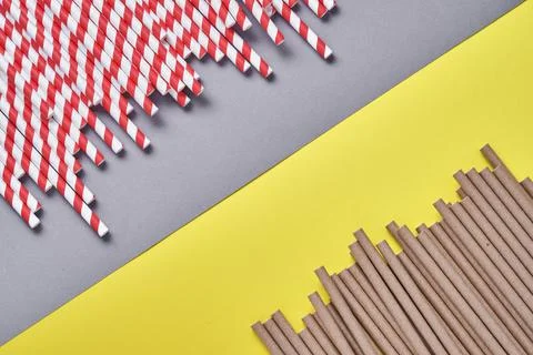 Drinking tubes red and brown made of paper and cornstarch, biodegradable mate Stock Photos