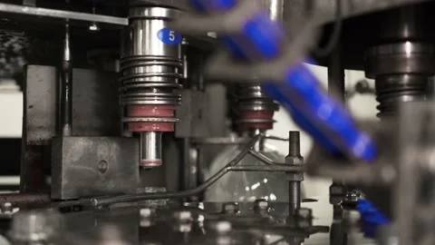 Drinking water bottling production. Screws the plastic cap onto the bottle. Stock Footage 162760668