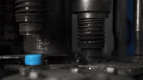 Drinking water bottling production. Screws the plastic cap onto the bottle. Stock Footage 162761470