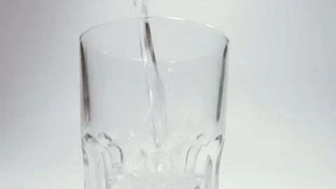 Drinking water. Drinking water is poured into a glass. Filmed in slow motion. Stock Footage 128941164