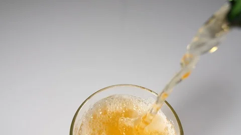 A drinking water glass of beer bubbles with poured liquid from above Stock Footage 88509338