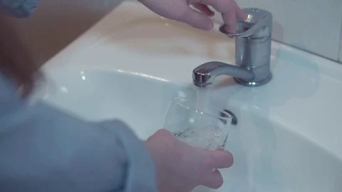 Drinking water from kitchen tap Stock Footage 85281359