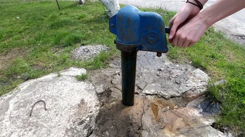 Drinking water from an old metal column. Stock Footage 130256005