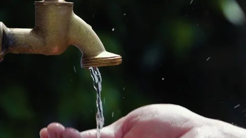 Drinking water out of old water tap faucet - slow motion shot Stock Footage