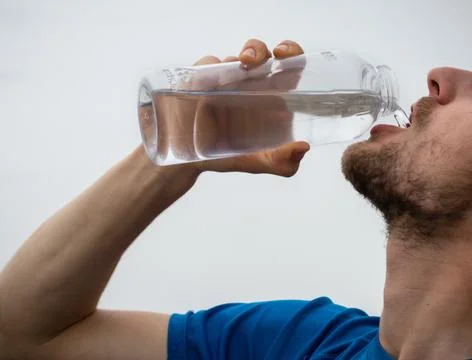 Drinking water from a plastic bottle Stock Photos
