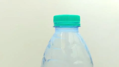 Drinking water in a plastic bottle on a white background Video stock 310868836