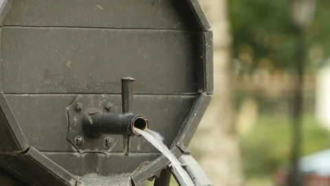Drinking water pours from an old barrel Stock Footage 228467939