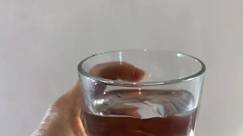 Drinking Water POV – Hand Holding Glass on Light Background Stock Footage 324811545