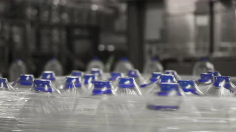 Drinking water production. Bottles packed with polyethylene sending supermarket Stock Footage 162975178