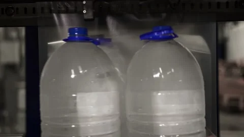Drinking water production. Bottles packed with polyethylene sending supermarket Stock Footage 162975320