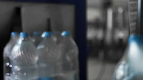 Drinking water production. Bottles packed with polyethylene sending supermarket Stock Footage 162975543