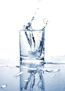 Drinking water splashed with ice in glass Stock Photos