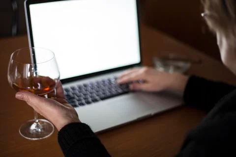 Drinking while working on laptop Stock Photos