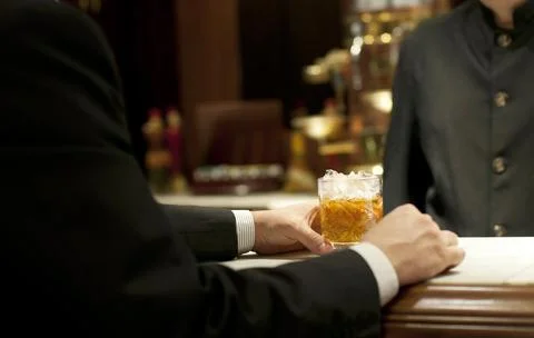 Drinking whiskey at the bar Stock Photos
