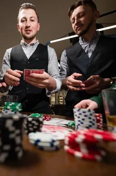 Drinking whiskey in a bar while playing poker. 스톡 사진