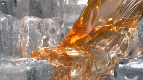 Drinking Whiskey is pouring with Ice inside a Glass in High Speed Stock Footage 124124128