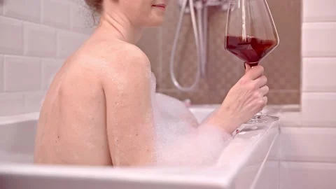 Drinking wine in bath tube. Stock Footage 144098657
