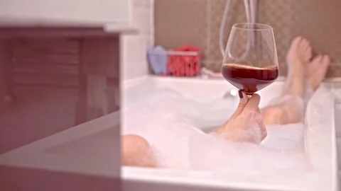 Drinking wine in bath tube. Stock Footage 144098871