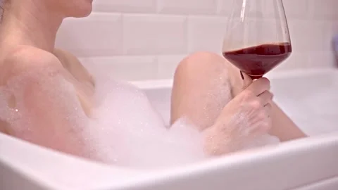 Drinking wine in bath tube. Stock Footage 144098877