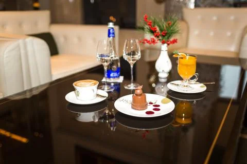 Drinks and desserts on table in cafe Stock Photos