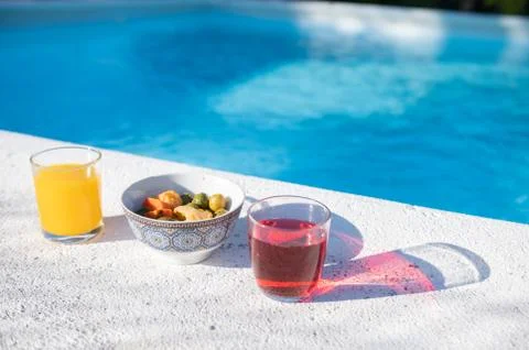 Drinks and snacks by the pool. Stock Photos