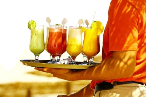 Drinks on the beach. Waiter serving drinks and cocktails on beach Stock Photos