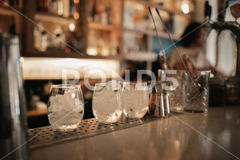 Drinks being prepared on a bar counter at night Stock Photos