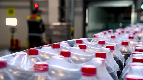 Drinks packaged in plastic bottles and wrapped in thick film in a warehouse.. Stock Footage 305988432
