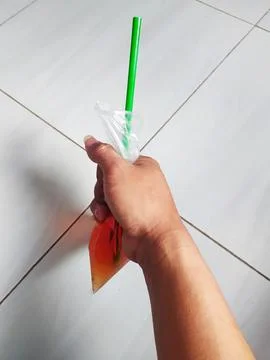 Drinks in plastic and in hand Stock Photos