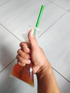 Drinks in plastic and in hand Stock Photos