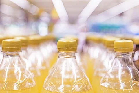 Drinks in plastic bottles with brown tops at the supermarket Stock Photos