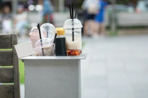 Drinks in the trash bin at the city. Stock Photos